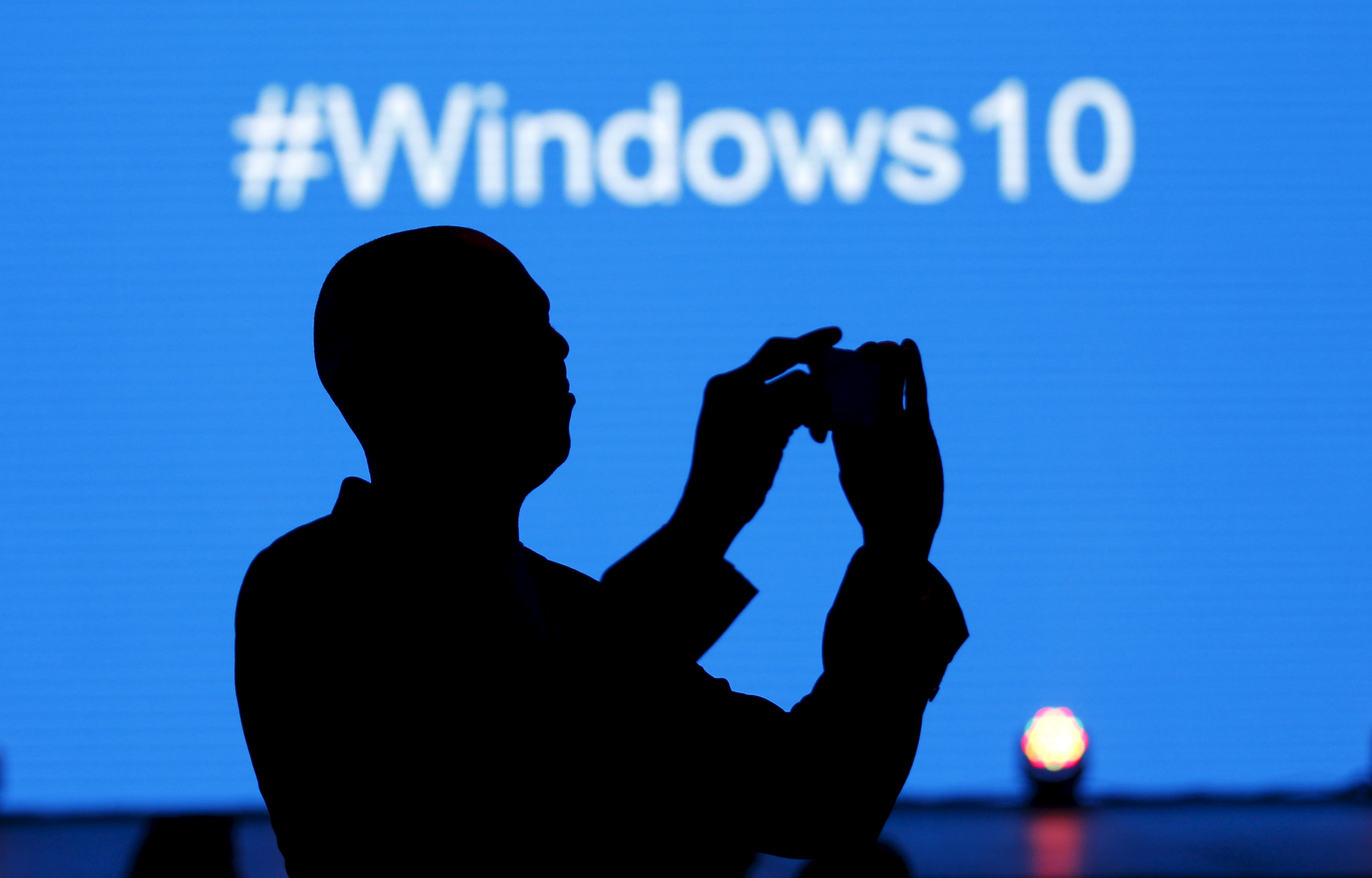 A Microsoft delegate takes a picture during the launch of the Windows 10 operating system in Kenya's capital Nairobi, July 29, 2015. (Reuters)