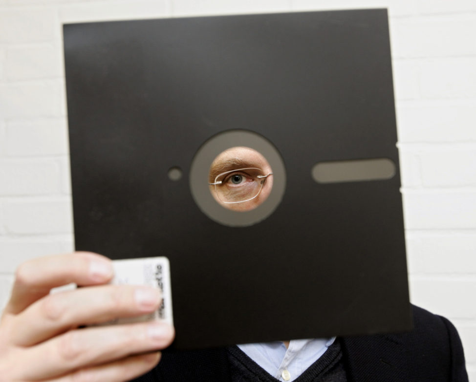 FILE - An obsolete 8 and 1-half inch floppy disc is held in London, England. (AP)