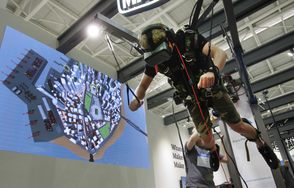 A video game enthusiast experiences the VR virtual reality headset with a skydiving game during the Computex Taipei exhibition at the world trade center in Taipei, Taiwan, May 31, 2016. (AP)