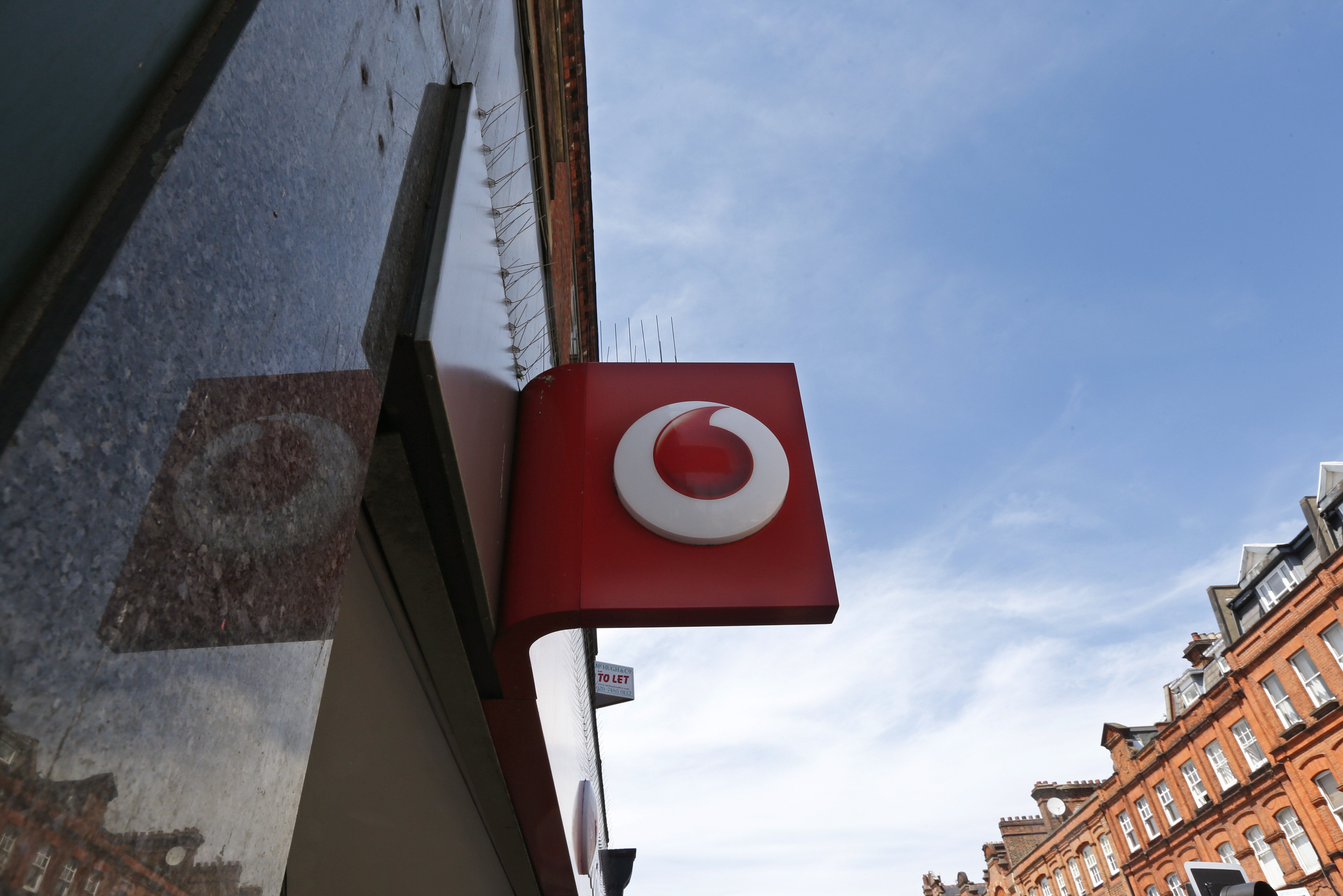 FILE - A Vodafone sign is seen outside a shop in London, on June 6, 2014. 