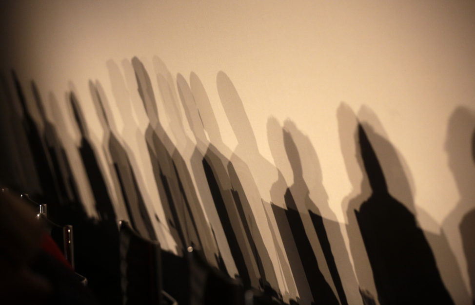 FILE - Shadows of members of a panel are reflected on a wall before a meeting about the 'right to be forgotten' in Madrid, Spain, Sept. 9, 2014. The panel debated the balance between privacy and the free flow of information in Europe. (EU) 