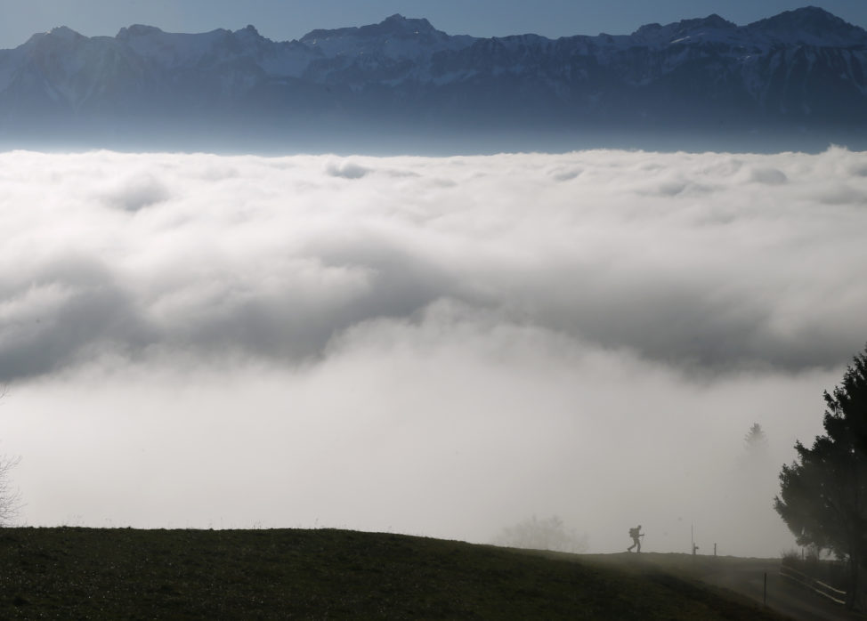 FILE - A hiker walks into a sea of fog over Lake Leman at the Tour de Gourze near Lausanne, Switzerland, Dec. 3, 2015. (Reuters)