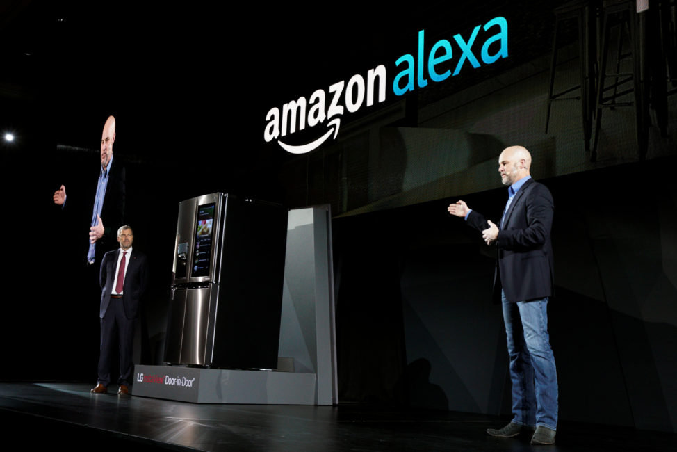 David VanderWaal, VP of marketing for LG Electronics USA (L), listens to Mike George, VP Alexa, Echo and Appstore for Amazon, talking about their companies' partnership to bring Amazon's digital assistant Alexa to LG appliances, during the LG press conference at the Consumer Electronics Show in Las Vegas, Jan. 4, 2017. (Reuters)