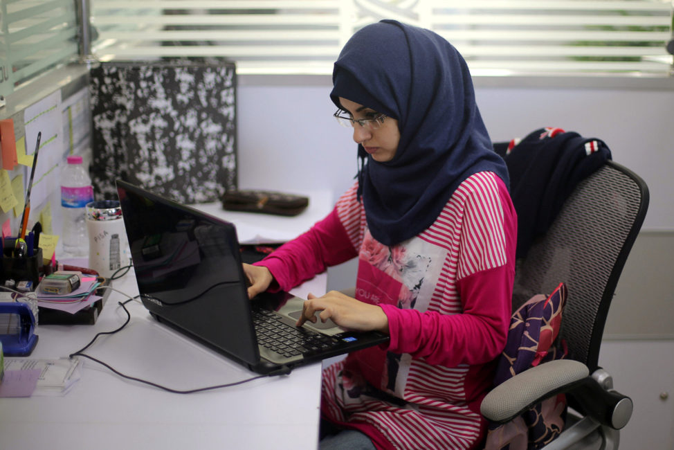 FILE - Palestinian entrepreneur Samar Hijjo, who developed the mobile application ''Baby Sitter' that is aimed at raising awareness of women during pregnancy and after giving birth, works at UCAS Technology Incubator office in Gaza City, Oct. 31, 2016. 