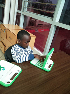 A child uses a laptop provided by One Laptop per Child at a public library in Kigali, Rwanda. (OLPC)