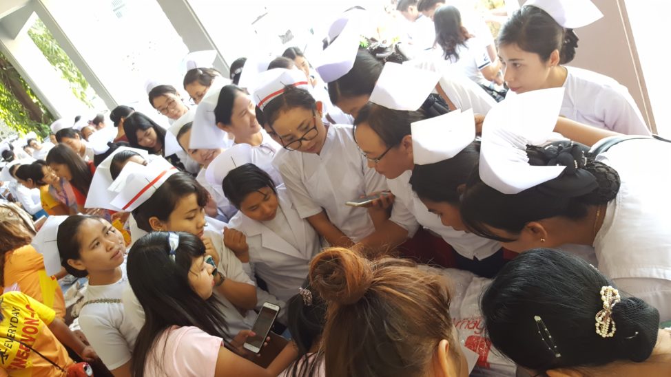 Nurses and midwives in Myanmar gather around to consult MayMay, an app with 60,000 active monthly users, for information on pregnancy and mother and infant health. (Michael Lwin for Koe Koe Tech)
