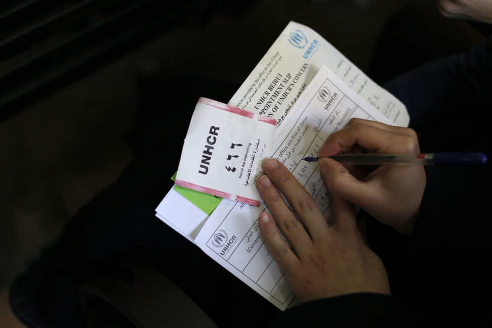 A Syrian woman fills out a document as she waits to register at the United Nations High Commissioner for Refugees headquarter in Beirut, Lebanon, Jan. 30, 2017. (AP)