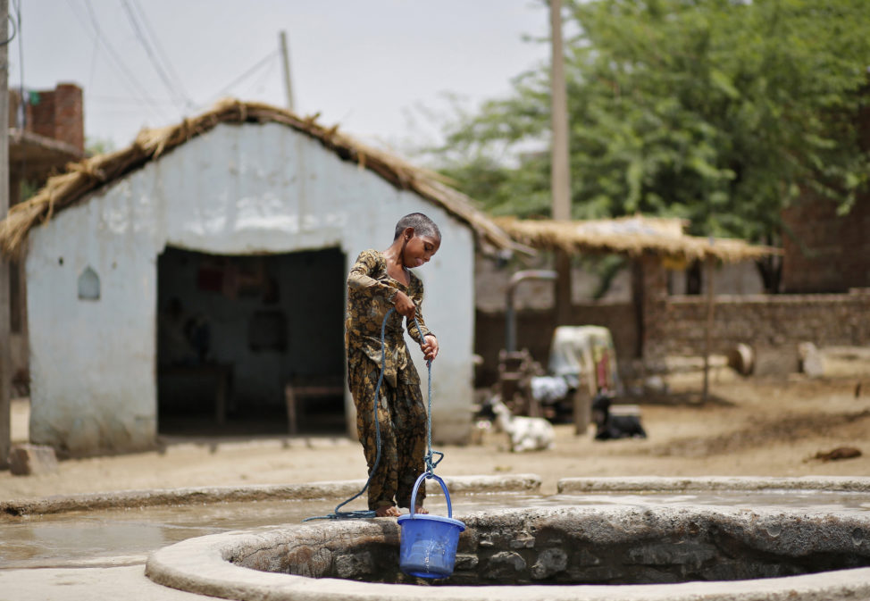 FILE - A girl fetches water from a well at Mewat district in the northern Indian state of Haryana, June 25, 2014. (Reuters)