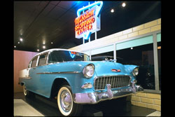 The “good life” depicted in the Johnson County Museum’s exhibit on suburbia, certainly included a nice car like this 1955 Chevy Bel-Air, and a convenient shopping center. (Johnson County Museum)