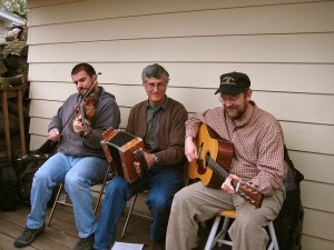 This is the “Cajun Strangers” band between gigs. The middle fellow is playing the “squeezebox,” a single-row accordion that’s lighter and simpler to play than the full accordion you might hear in a German polka band. (psforsberg, Flickr Creative Commons)