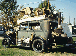 A classic jalopy, overloaded for the trip to California.  (weedpatchcamp.com)