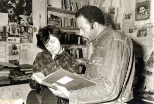 Jane Friedman and Eldridge Cleaver look over something, perhaps a scrapbook, at his apartment in a working-class neighborhood of Paris. (courtesy, Jane Friedman)