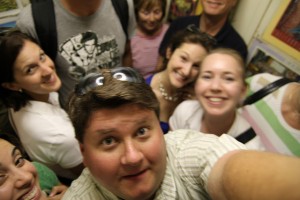 A very unrealistic crowded elevator.  Why? Because these folks are SMILING. (particlem, Flickr Creative Commons)