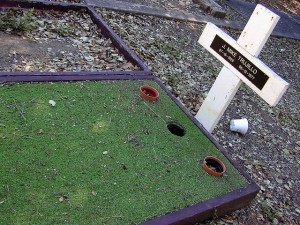 This is not a clever course obstacle.  It's an actual grave of what, we can only presume, was a serious mini-golf enthusiast. (Dawn Endico, Flickr Creative Commons)