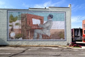 A mural on the side of an old furniture outlet downtown shows Scott Joplin at work.  (Carol M. Highsmith)