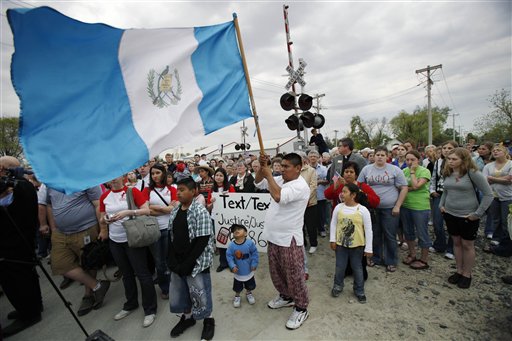 There were protests immediately after the I.C.E. raid, and this one on the one-year anniversary, in which the flag of Guatemala is waved proudly.  (AP Photo/ Charlie Neibergall)