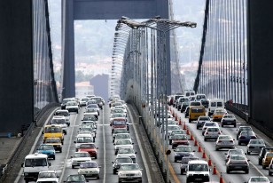 Motorists drive over the Bosphorus suspension bridge linking the city's Asian and European sides in ..