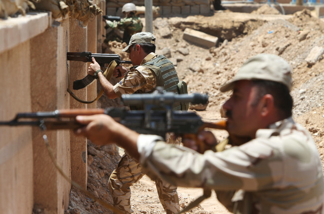 Kurdish peshmerga fighters take their positions on the front line with Islamic State militants in Tuz Khormato, south of  Kirkuk, northern Iraq,  June 25, 2014..(AP Photo/Hussein Malla)