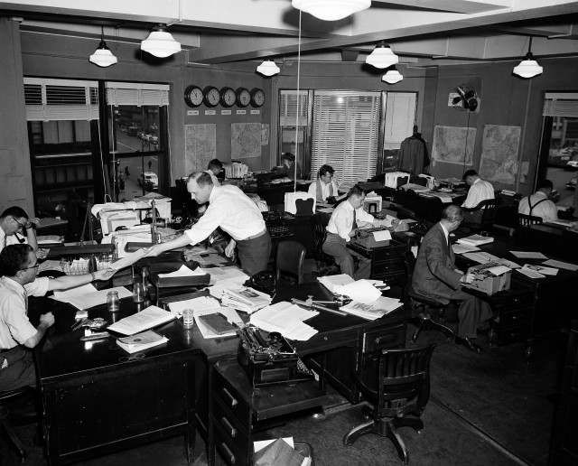 VOA journalists shown working in the central programming services division of Voice of America in New York on Feb. 27, 1953.  (AP Photo/John Rooney)