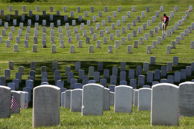 Tom Nicholson of Gretna, Neb. visits graves at Arlington National Cemetery in Arlington, Va., Monday,May 25, 2015. (AP Photo/Jacquelyn Martin)