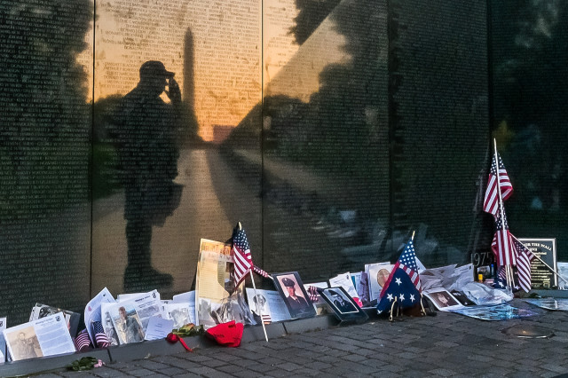 Army veteran Bernie Klemanek, of Mineral, Va., stops to salute his fallen comrades at the Vietnam War Memorial in Washington, May 25, 2015. (AP Photo/J. David Ake)