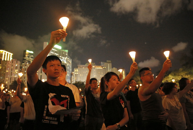 People attend a candlelight vigil in Hong Kong on June 4, 2015 to mark the 1989 crackdown on student-led protests in Tiananmen Square. (AP Photo/Vincent Yu)