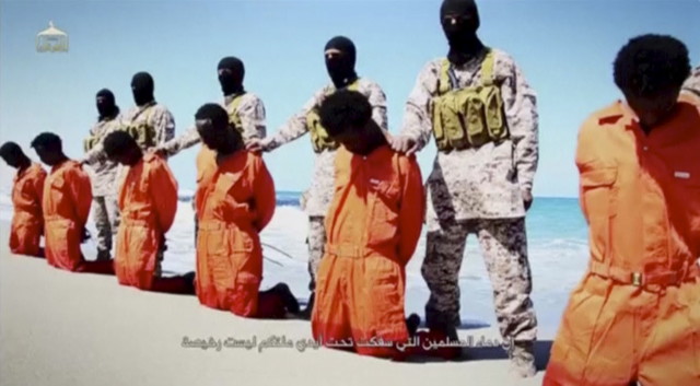 Islamic State militants stand behind what are said to be Ethiopian Christians in this still image from an undated video made available on a social media website on April 19, 2015.  (Reuters)