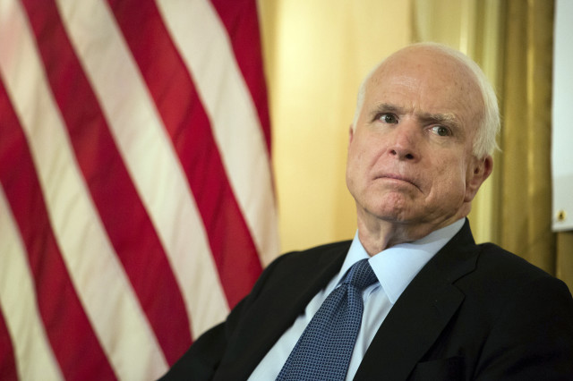 Sen. John McCain, R-Ariz., listens as Republican presidential candidate Lindsey Graham defends McCain's military record on July 20, 2015 in New York. (AP)