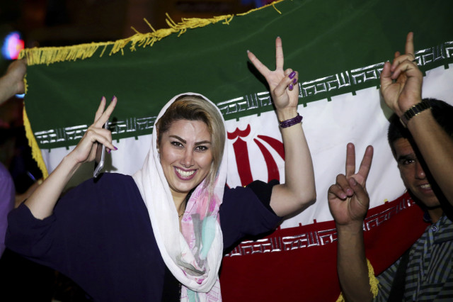 An Iranian woman shows the victory sign during street celebrations following a landmark nuclear deal, in Tehran, Iran, July 14, 2015.  (AP)