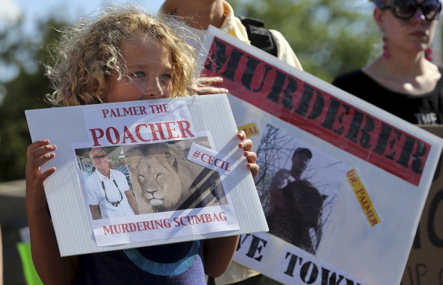 Protestors outside office of American hunter accused of killing Cecil the lion. (Reuters) 