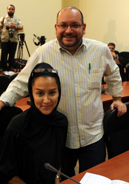 Iranian-American Washington Post correspondent Jason Rezaian and his Iranian wife Yeganeh Salehi posing while covering a press conference at Iran's Foreign Ministry in Tehran, on September 10, 2013. (AFP PHOTO/STR)