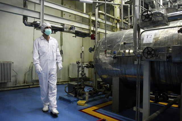In this Feb. 3, 2007 file photo, an Iranian technician walks through the Uranium Conversion Facility just outside the city of Isfahan, south of the capital Tehran. (AP)