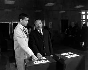 Julian Bond and Dr. Martin Luther King Jr. cast ballots  to fill Bond's vacant seat in the U.S. House of Representatives in Atlanta, Ga. on Feb. 23, 1966. (AP)