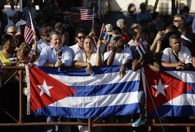 People wait  behind barriers to catch a glimpse of the flag raising ceremony near  the U. S.  Embassy in Havana, Cuba on Aug. 14, 2015.  (AP)