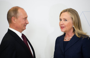 Then US Secretary of State Hillary Clinton (R) talks with Russian President Vladimir Putin at APEC Summit in Vladivostok, Russia, Sept. 8, 2012. 