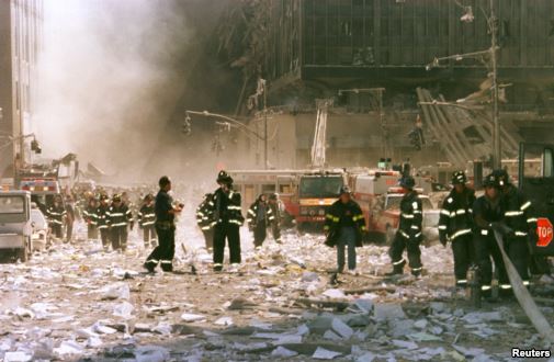 New York City firefighters and other emergency personnel survey the World Trade Center collapse area near Vessey and Greenwich Streets. (Reuters)