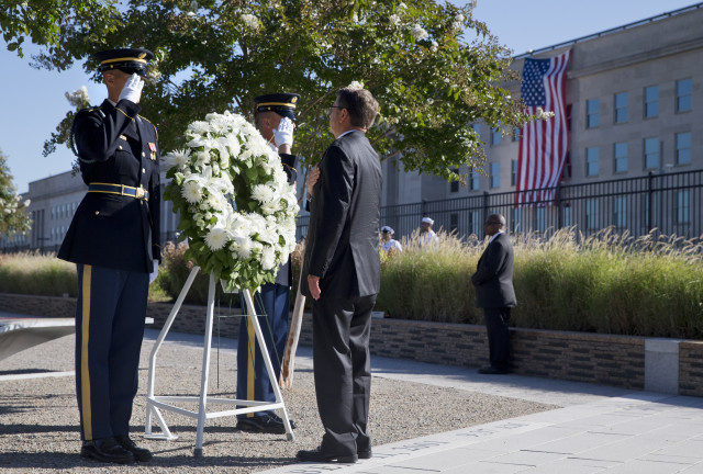 Defense Secretary Ash Carter attends a wreath ceremony during a memorial for the 14th anniversary of the September 11th attacks, Sept. 11, 2015, at the Pentagon.