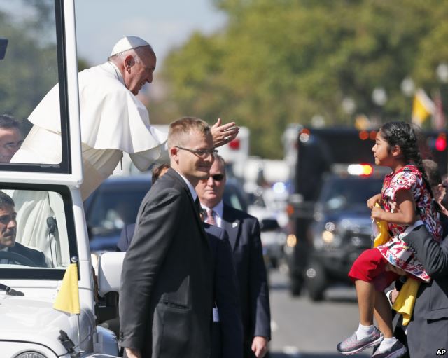 Pope Francis reaches to give a blessing to Sophie Cruz, 5, from suburban Los Angeles, during a parade in Washington, Sept. 23, 2015. Cruz said she managed to deliver a message to the pope. "I believe I have the right to live with my parents,'' Sophie said later in the day. "I have the right to be happy. My dad works very hard in a factory galvanizing pieces of metal. All immigrants just like my dad feed this country. They deserve to live with dignity. They deserve to live with respect.'' (AP) 