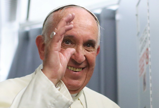 Pope Francis smiles onboard the papal plane during his return to Rome, from Asuncion, Paraguay, July 12, 2015. (Reuters)