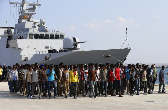 Migrants disembark from the Italian Navy vessel Cigala Fulgosi in the Sicilian harbor of Augusta, Italy, Sept 3, 2015. (Reuters)