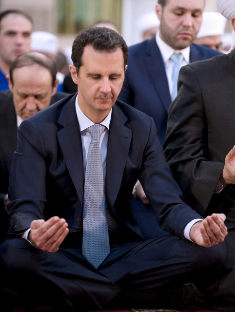 Syria's President Bashar al-Assad attends prayers on the first day of Eid al-Adha at al-Adel mosque in Damascus, Syria, in this handout photograph released by Syria's national news agency SANA on Sept. 24, 2015. (Reuters)