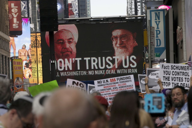 An image of Iranian leaders is projected on a giant screen  during a rally apposing the nuclear deal with Iran in New York's Times Square, July 22, 2015. (Reuters)