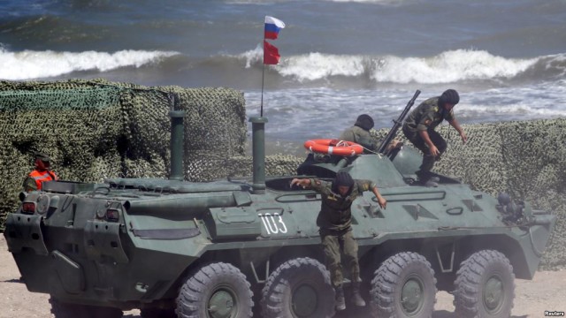 FILE - Russian navy personnel are seen disembarking from an armored personnel carrier (APC) in Kaspiysk, Russia, Aug. 5, 2015. (Reuters) 