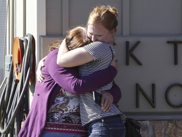 Donice Smith (L) is embraced after one of her former teachers was killed in a mass shooting at Umpqua Community College in Oregon on Oct. 1, 2015. 