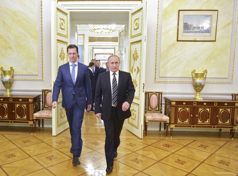 Russian President Vladimir Putin (R) and Syrian President Bashar al-Assad head to a meeting at the Kremlin in Moscow on Oct. 20, 2015. (Reutetrs)