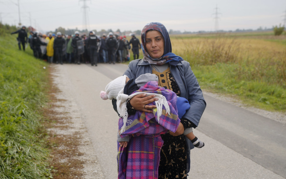 Fatima from Syria (front) walks ahead of other migrants as they make their way on foot after crossing the Croatian-Slovenian border in Slovenia on Oct. 22, 2015. (Reuters)