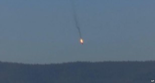 This frame grab from video by Haberturk TV, shows a Russian warplane on fire before crashing on a hill as seen from Hatay province, Turkey, Nov. 24, 2015. (AP) 