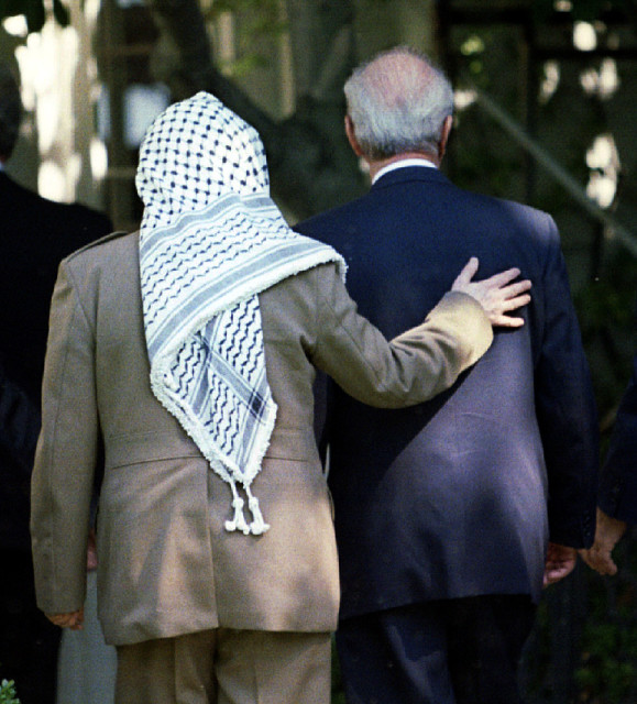 PLO chairman Yasser Arafat (l) puts his arm around Israeli Prime Minister Yitzhak Rabin as they enter the  White House on Sept. 28, 1995 prior to the signing of an Israeli-PLO accord. (Reuters)