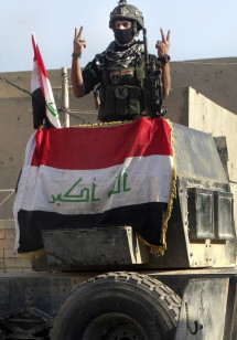 An Iraqi soldier flashes the victory sign after entering the government complex in central Ramadi, west of Baghdad, Iraq, Dec. 28, 2015. (AP)