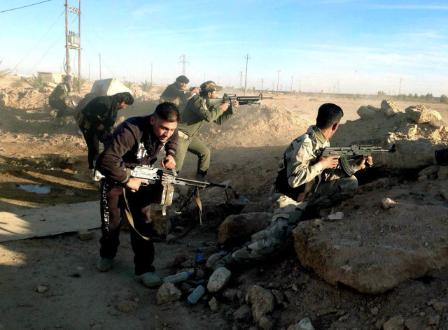 Iraqi security forces take combat positions on the front line with Islamic State group militants in Ramadi, capital of Iraq's Anbar province, 70 miles (115 kilometers) west of Baghdad, Thursday, Dec. 10, 2015. (AP)